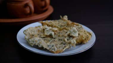 Tempe Geplung or Tempe Mendoan on a white plate. Indonesia food.