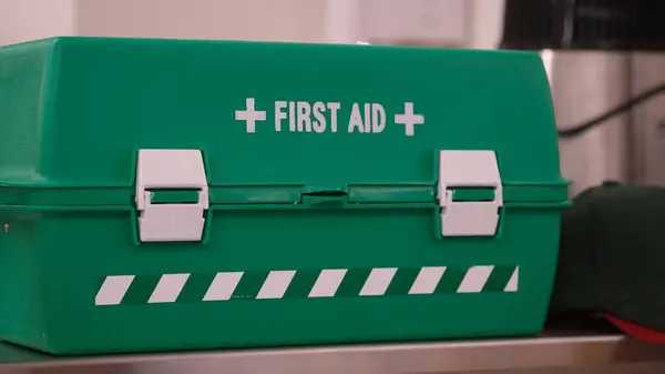 A box of First Aid in green color on a table.
