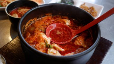 Korean spicy seafood soft tofu stew. clipart