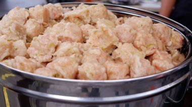 Siomay Bandung which consists of siomal mackerel, tofu and bitter melon and cabbage in a steaming pot. clipart