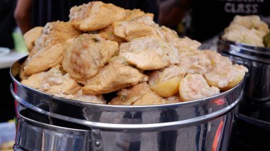 Siomay Bandung which consists of siomal mackerel, tofu and bitter melon and cabbage in a steaming pot. clipart