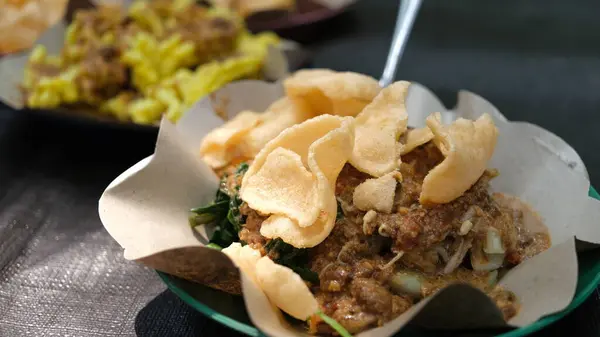 stock image A plate of Pecel. Pecel is is a traditional Javanese salad with peanut sauce, usually eaten with steamed rice, lontong or ketupat.The simplicity of its preparation and cheap price.