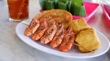 Shrimp satay on a white plate. clipart