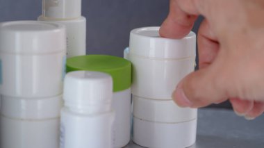 Recycled empty containers used to produce beauty care creams clipart