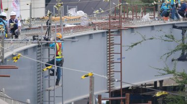 Construction workers are completing the construction of the Jakarta LRT Phase 1B from Voledrome to Manggarai. Jakarta , 28 August 2024 clipart