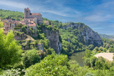Saint-Cirq-Lapopie. Eglise fortifiee du village et riviere le Lot.  Occitanie
