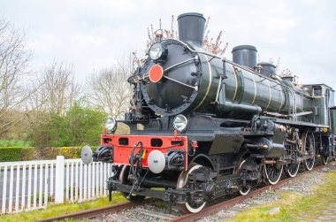 Yan taraftan eski buharlı lokomotif görünüyor 