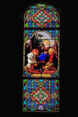 Stained glass window from the Notre-Dame-de-l'Assomption church in Vouvant, built between 1016 and 1019 in Romanesque style. clipart