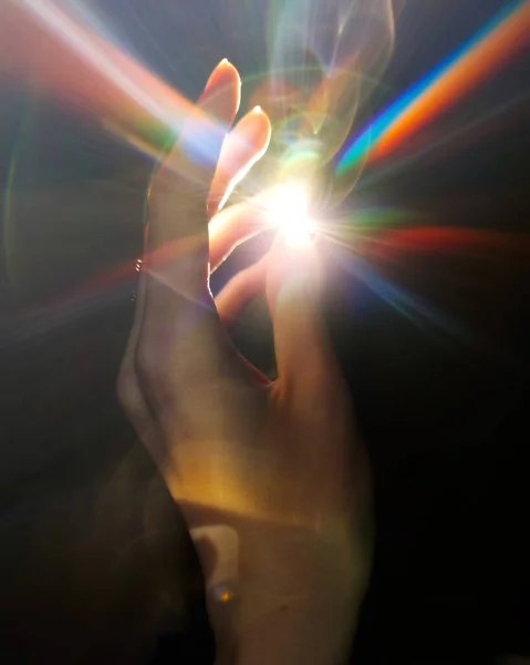 Colorful light in the human hands in the dark, stock photo and image. High quality photo