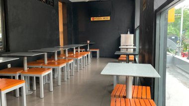 The benches and tables in the cafe are neatly arranged
