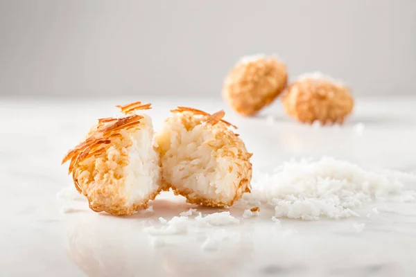 This is a high-quality product photography of delicious Coconut Shrimp, shot with an 85mm lens. The photo features a close-up view of the shrimp dish, with golden brown, crispy shrimp coated in a coconut breading and garnished with fresh herbs. The d