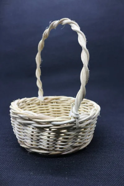 wicker basket with wooden baskets, on a brown background, a place of this image for text