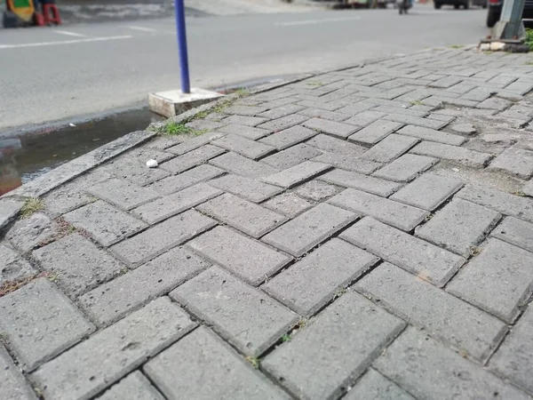 stock image Street pavement with a white background. Cobblestone road in the city, closeup of photo