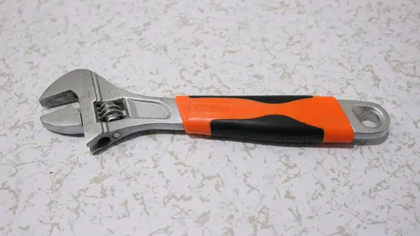 Adjustable Wrench Orange Grip White Floor — Stock Photo, Image