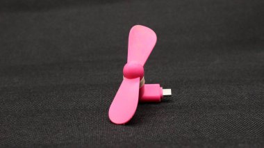 Taşınabilir USB pembe fan siyah arkaplanda izole edildi