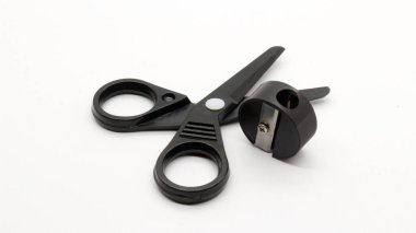 Siyah makaslı ve siyah kalemtıraşlı beyaz arka planda küçük bir boyut..