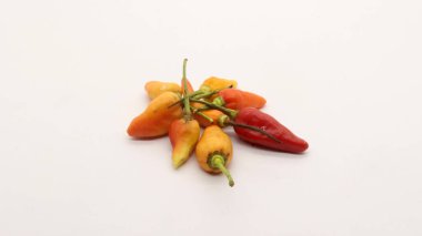 Beyaz arka planda kırmızı biber, taze bir mutfak baharatına benziyor..