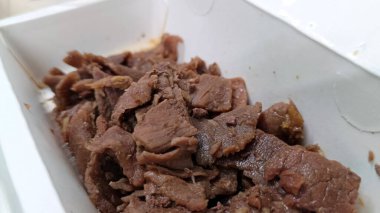 Pişmiş ve paketlenmiş et parçaları, servis edilmeye ve yenmeye hazır.