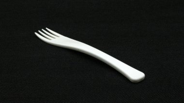 Siyah arkaplanda beyaz plastik çatal