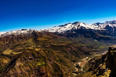 beautiful view of the slopes of the chilean andes on a clear spring day under a radiant blue cloudless sky from the meceta