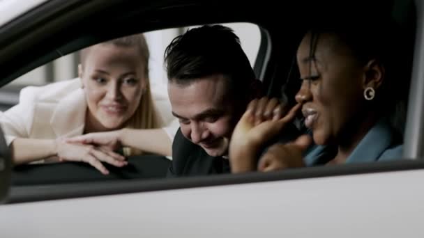 Klienci Sprawdzają Nowy Samochód Nowoczesnym Salonie Atrakcyjny Sprzedawca Mówi Samochodzie — Wideo stockowe