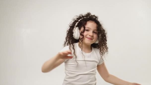 Little Charming Curly Girl Charming Smile Listens Music Wireless Headphones — Wideo stockowe
