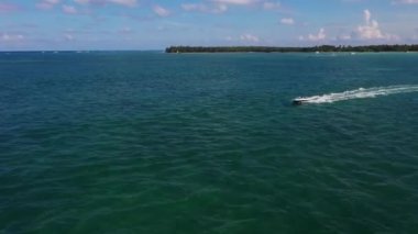 Luxurious yachts anchored on blue azure lagoon around tropical islands with resorts and bungalows in Dominican Republic, drone view 4k.