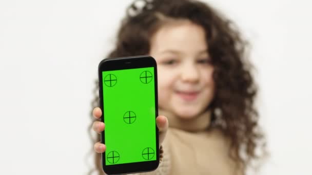 Little Girl Shows Smart Phone Blank Horizontal Green Screen Chroma — Stockvideo