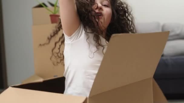 Portrait Little Girl Jumping Out Cardboard Box Showing Keys New — Stockvideo