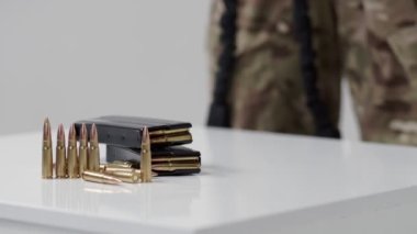 Black iron modern army military machine gun and cartridges, small arms for soldiers with an optical sight lie on a white background. Close-up