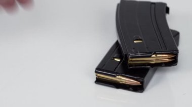 Black iron modern army military machine gun and cartridges, small arms for soldiers with an optical sight lie on a white background. Close-up