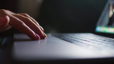 Female hands write text messages on a laptop keyboard close-up. Busy business woman emailing a client using a digital wireless handheld device remotely. Software, online education, apps, concept