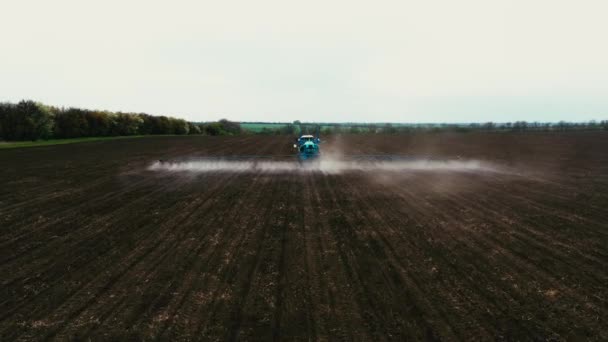 トラクター日没時にフィールドの耕起 耕された耕起のトラクター 水をやり 種子の播種と散水のためのフィールド内の農業トラクター 畑を耕すときの大きなトラクター — ストック動画