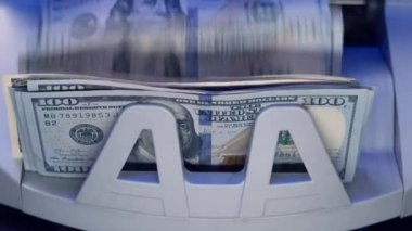 A counting machine for counting dollar bills. Banking and commercial activities. Quick cash loan. Bank automatic equipment for counting paper money. Close up cash counting equipment