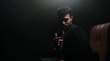 Ciddi bir yüzü olan sakallı bir adamın portresi birkaç saniye kameraya bakıyor ve sonra başını çevirip başka tarafa bakıyor..