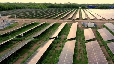 Aerial view of Solar Panels Farm (solar cell) with sunlight. Drone flight over solar panels field, renewable green alternative energy concept.
