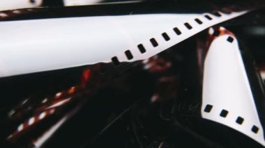 Watching Retro Pictures on Negative Plastic Film Strip Roll