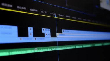 The movie editor highlights, selects, and moves footage in a timeline editing project in a computer program macro mode. time-lapse editing of a TV show, film