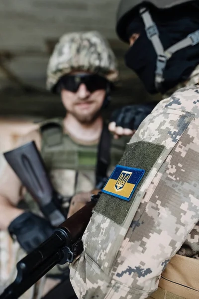 Ukraine Army Background. Ukrainian flag Symbol on Soldier Camouflage Uniform. Soldier of the Ukrainian Armed Forces. Victory concept. Copy Space.