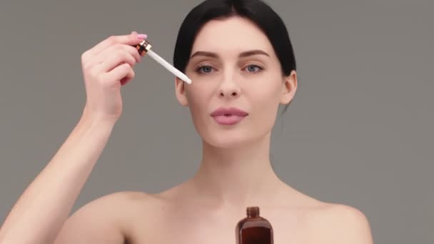 Large Close Attractive European Young Woman Applies Face Care Serum — Stock Video