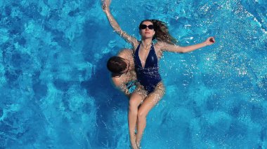 Yukarıdan bak. Çift havuzda eğleniyor. Genç ve çekici bir çift havuzda dinleniyor. Birbirimizin arkadaşlığından zevk alıyoruz..