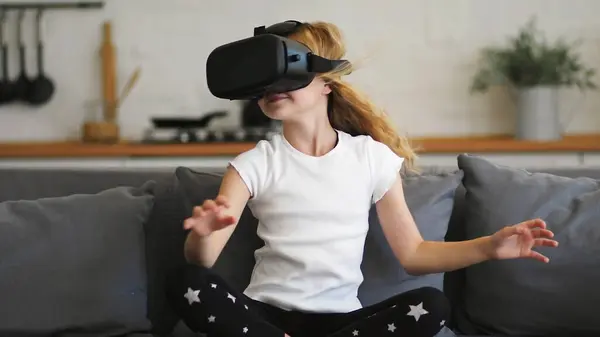 Young woman wearing virtual reality glasses and touching objects in 3d world, choosing goods and shopping in virtual store, working in augmented reality. Lady interacting with digital simulation app .