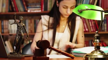 Female lawyer working with documents and laptop on research, brainstorming on career issues 