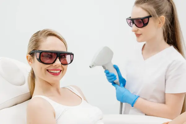 Profesyonel bir güzellik kliniğinde lazerle saç aldırma. Yetenekli bir teknisyen, pürüzsüz ve tüysüz bir cilt için prosedürü gerçekleştirir..