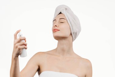 Kozmetik ürünlerle uğraşan genç bir kadının portresi. Vücudunda ve saç bakımında hidratasyon ve parlaklığın önemini vurgulayarak özgüven yayıyor..