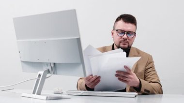 Bir iş adamı, finans müdürü ya da adam toplayıcı, modern bir ofiste bilgisayar başında çalışıyor. Konsept, rahat bir çalışma ortamında bir profesyonelin odaklanma ve üretkenliğini göstermektir..