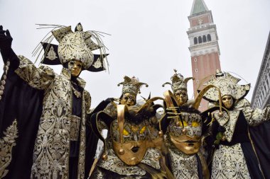 Group of men and women dressed up for the Venice carnival wearin