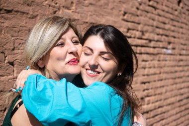 Anne ve kızı sarılıyor ve sevgisini dile getiriyorlar..