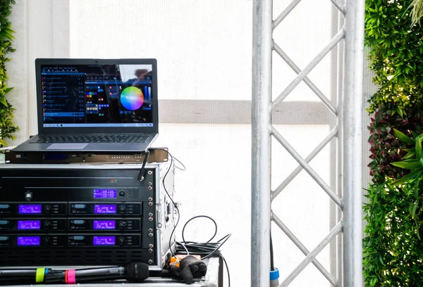 Sound and light system with laptop, microphones and DJ mixers