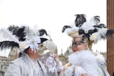 Couple of people dressed up for the Venice Carnival.